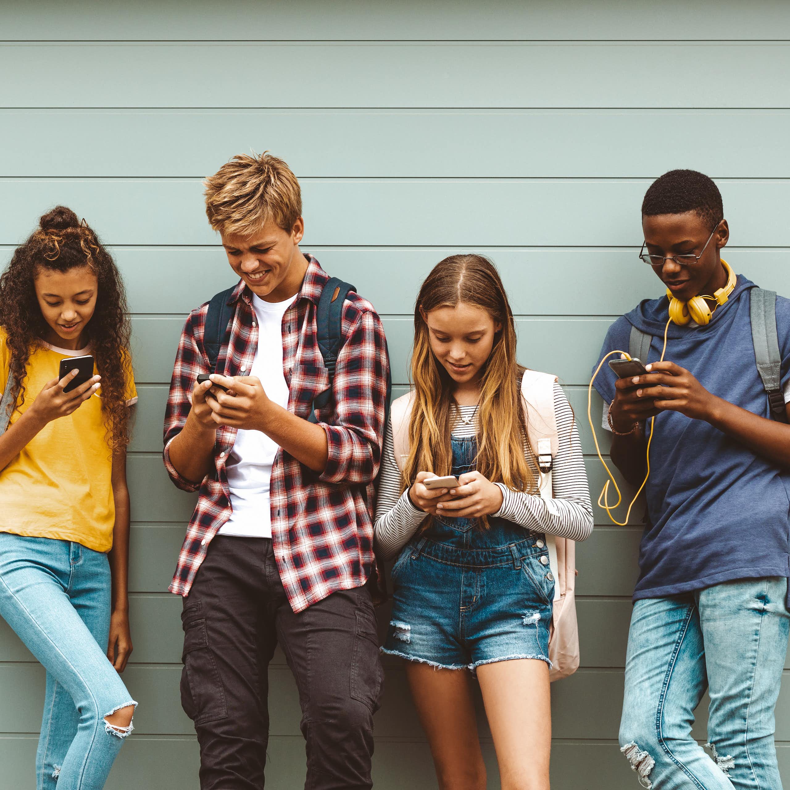Teenagers looking at phones
