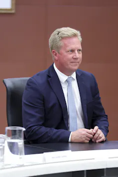 Todd McClay seated