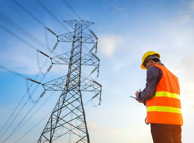 man assessing transmission lines