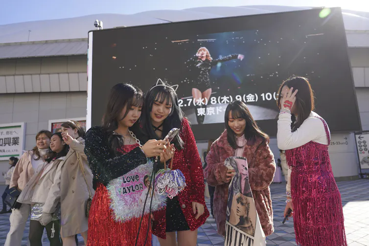 Fans wearing sparkly costumes at Taylor Swift's Eras Tour