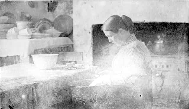 Faded photo, a woman in a kitchen.