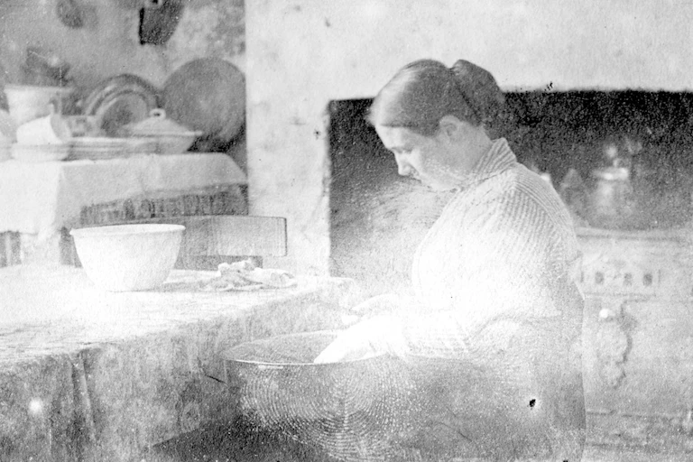Faded photo, a woman in a kitchen.