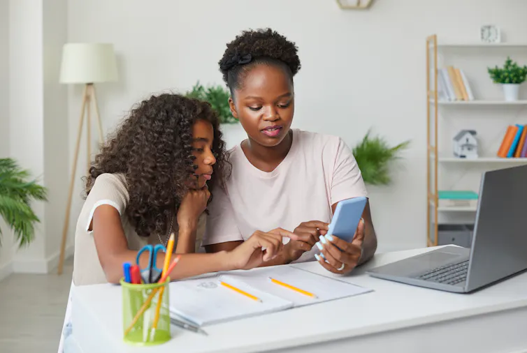 Mother and daughter looking at phone