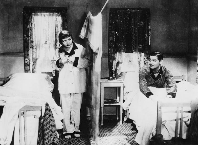 A curtain separates the two actors' beds.