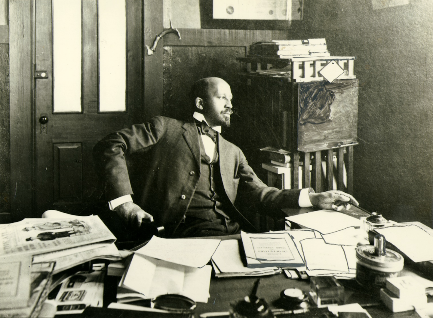 W.E.B. Du Bois seated at desk in office at Atlanta University in 1909