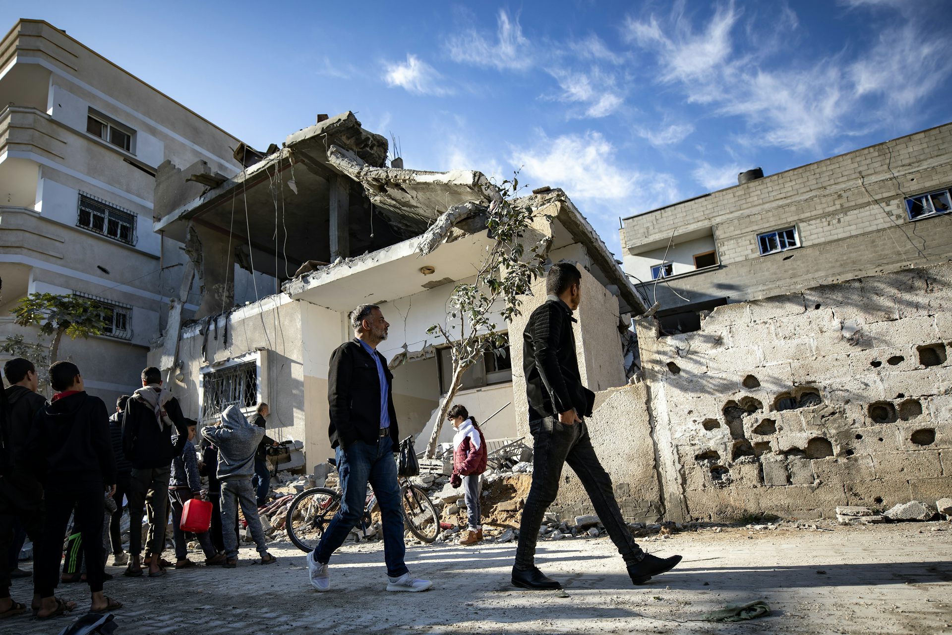 Palestinians walk through bomb-damaged streets in the city of Rafah, southern Gaza.