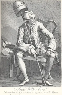 A black and white engraving by William Hogarth depicting John Wilkes holding a bell that reads 'liberty' and smiling demonically