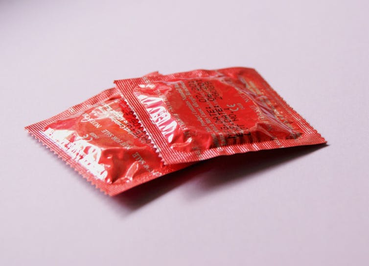 Photo of two condoms in red packages