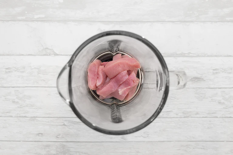 Raw chicken in a blender