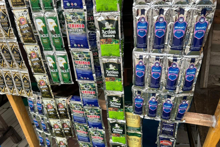 A wooden display frame covered with strips of sachets with various branding.