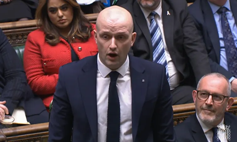 Stephen Flynn standing up and speaking in the House of Commons chamber.