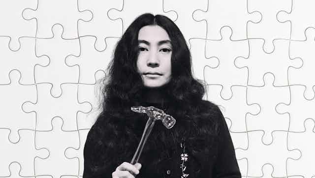 Yoko One with a glass hammer in her hand