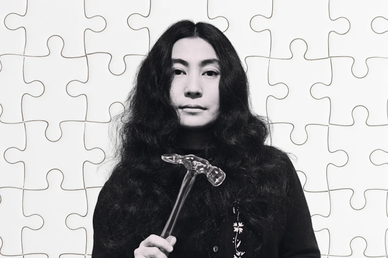 Yoko One with a glass hammer in her hand