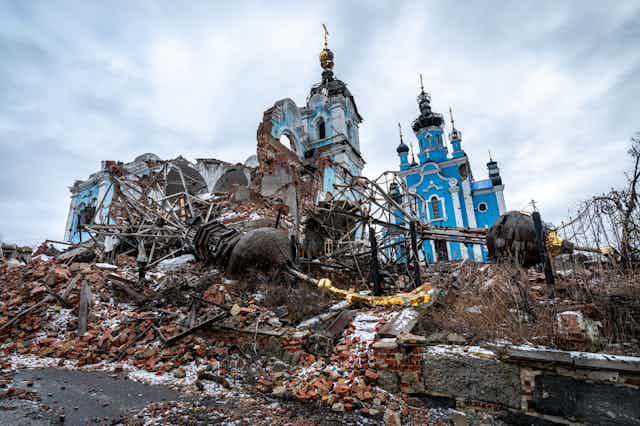 Ruins of a blue and white Orthodox church.