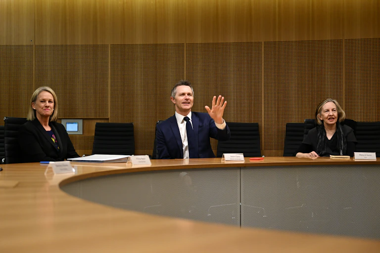Fiona Nash, Education Minister Jason Clare and Mary O'Kane sit at a table.