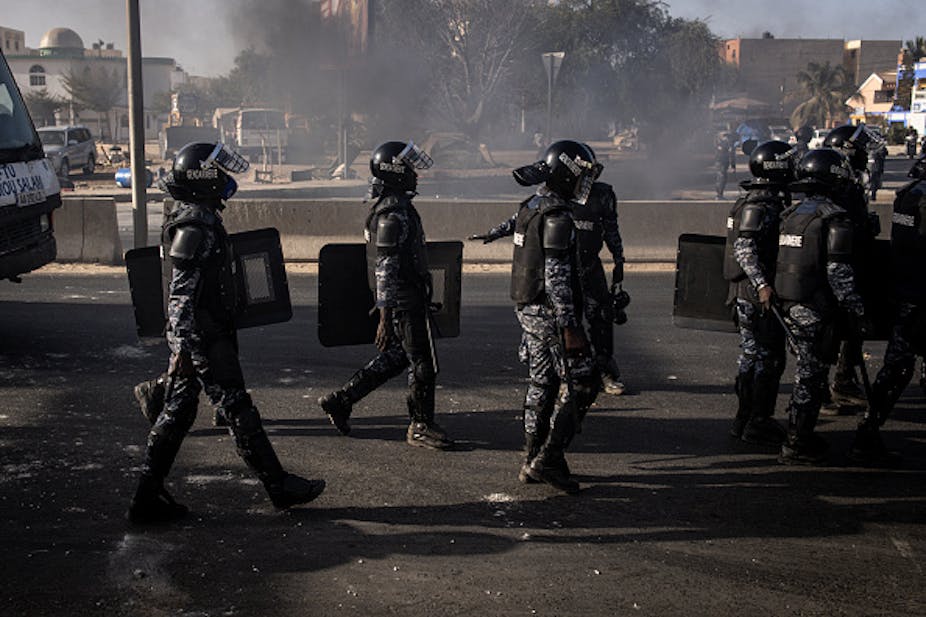 Police in riot gear on patrol.