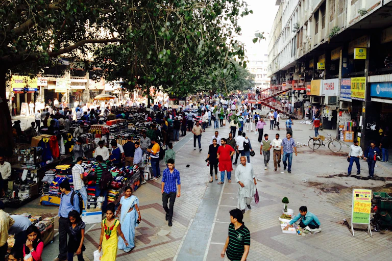 Crowds and street vendors in a large city.