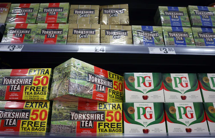 Boxes of tea on a supermarket shelf.