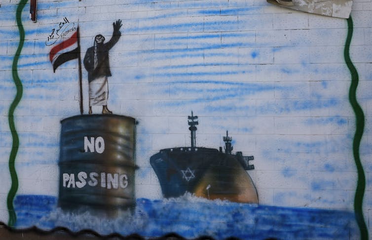 Graffiti on a wall in Sana'a depicting a Houthi fighter stopping an Israeli ship.