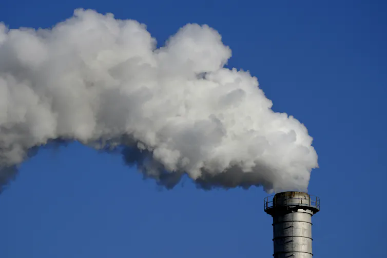 Smoke billowing out of a factory chimney