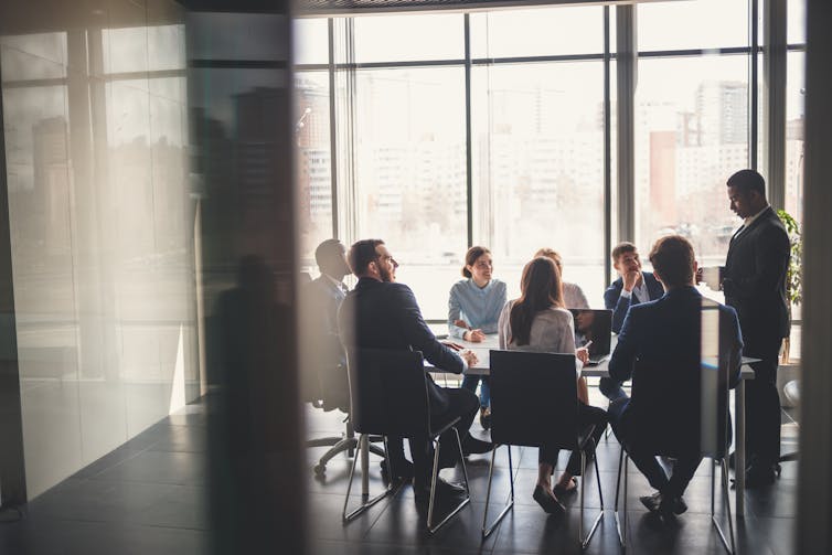 A group of people having a meeting in a conference room