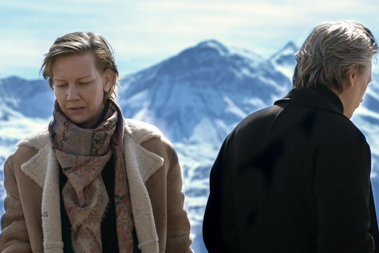 Film still: a man and a woman face away from each other
