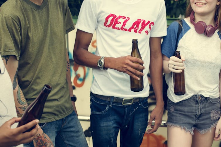 Teenagers with beer bottles.