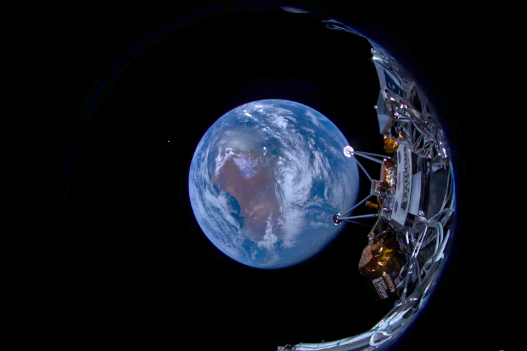 A crescent shaped spacecraft with Earth in the background