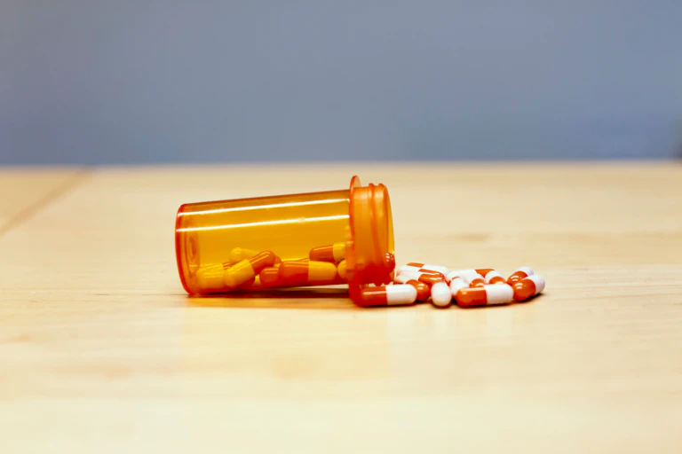 Pills spilling out of a bottle