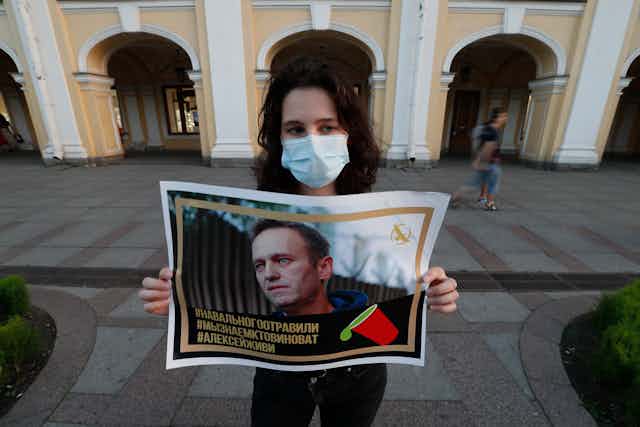 A supporters holds up a picture of Alexei Navalny after he was poisoned, August 2020.ia, 20 August 2020