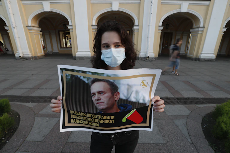 A supporters holds up a picture of Alexei Navalny after he was poisoned, August 2020.ia, 20 August 2020