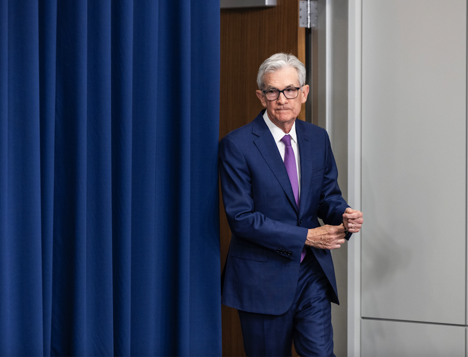 Jay Powell emerging from behind a curtain