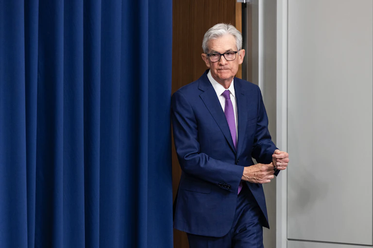 Jay Powell emerging from behind a curtain