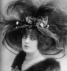 A Victorian lady in an enormous feathered hat.