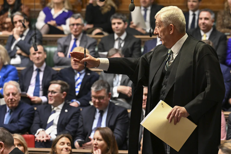 Lindsay Hoyle standing up and giving direction in the House of Commons with MPs in the background