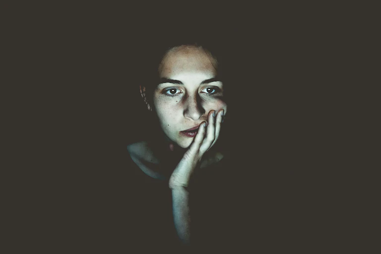 Woman looks at computer screen in the dark