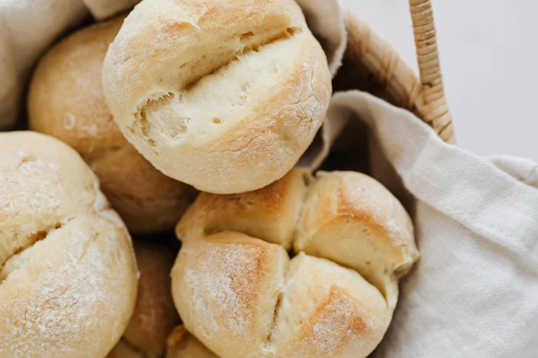 white bread rolls in basket