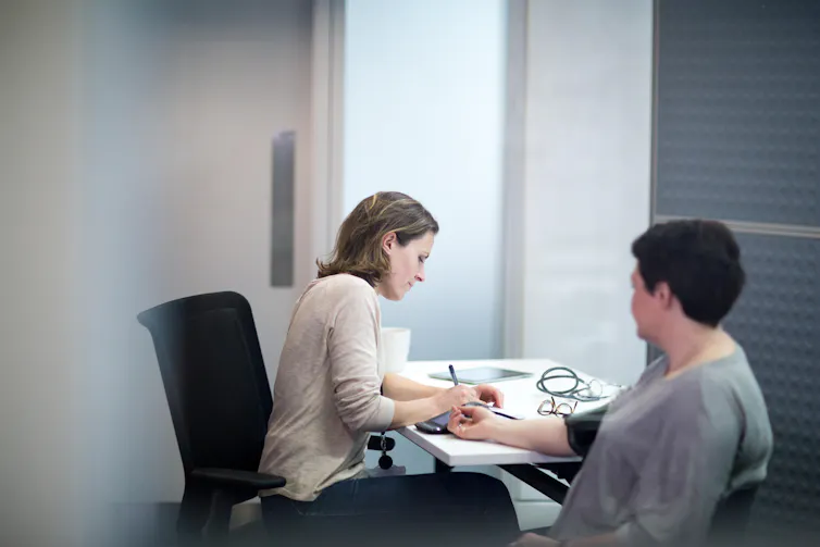 A doctor taking a patient's blood pressure