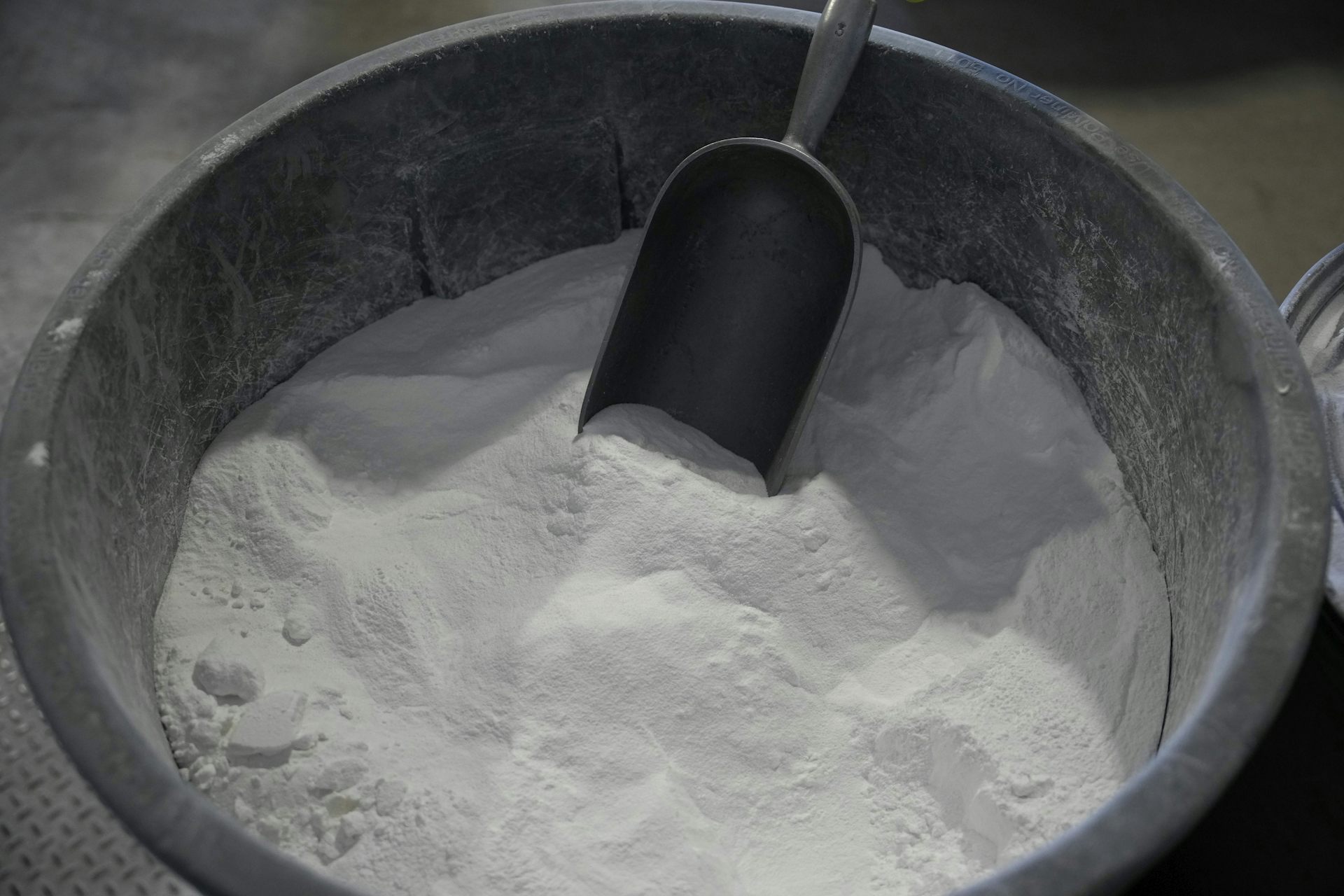 A bucket of white powder with a scoop.