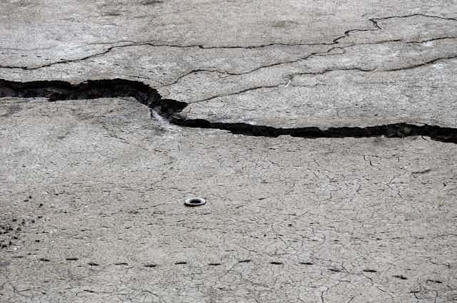 A road with a large crack in it.