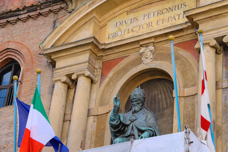 statue of Pope Gregory XIII with flags