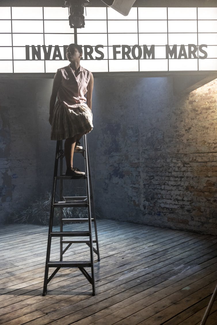 Production image: the actor on a ladder.
