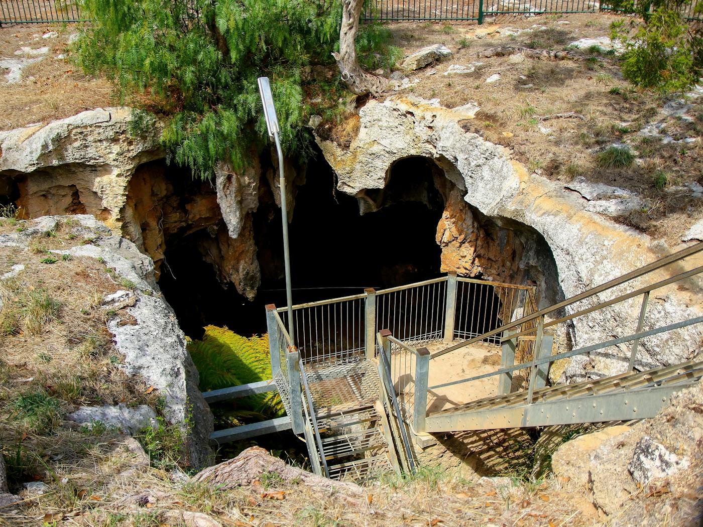 Metallic stairs leading down to the Stick-Tomato Cave through a sinkhole in the Naracoorte Caves National Park in South Australia