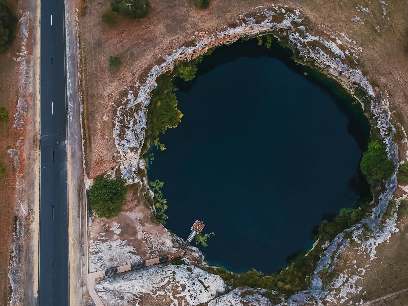A drone shot of 'Little Blue Lake' near Mt Schank, South Australia. An easily accesible local hotspot for cooling off in the extreme summertime heat.