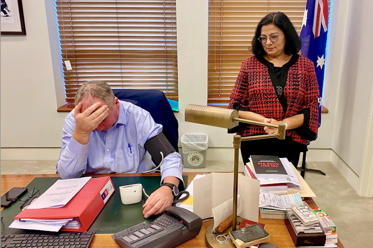 Barnaby Joyce head in hand, while having blood pressure monitored by Associate Professor Sutapa Mukherjee