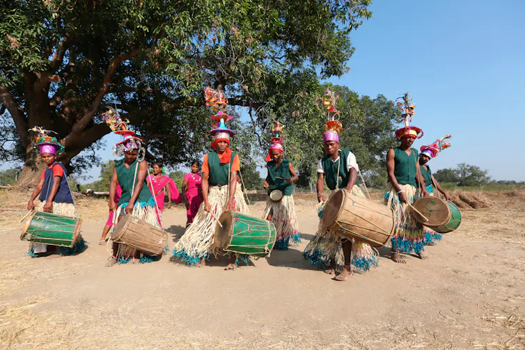 Dancers and drummers in traditional dress.