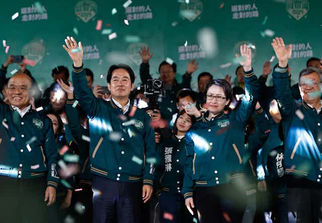 Taiwanese president-elect William Lai and vice presidential candidate Hsiao Bi-khim surrounded with supporters celebrate their victory celebrate their victory as confetti rains around them.