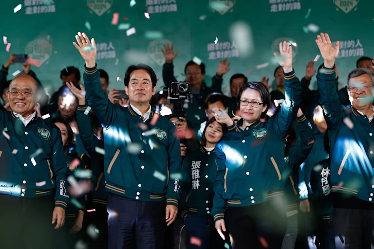 Taiwanese president-elect William Lai and vice presidential candidate Hsiao Bi-khim surrounded with supporters celebrate their victory celebrate their victory as confetti rains around them.