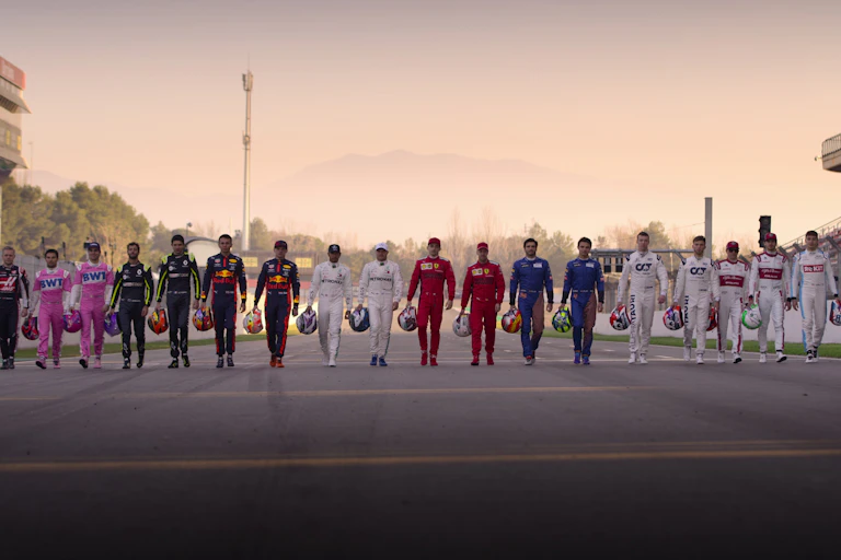 F1 drivers walking down the track.