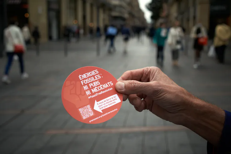 A sticker reading 'Fossil fuels: no advertising, no sponsorship' in French